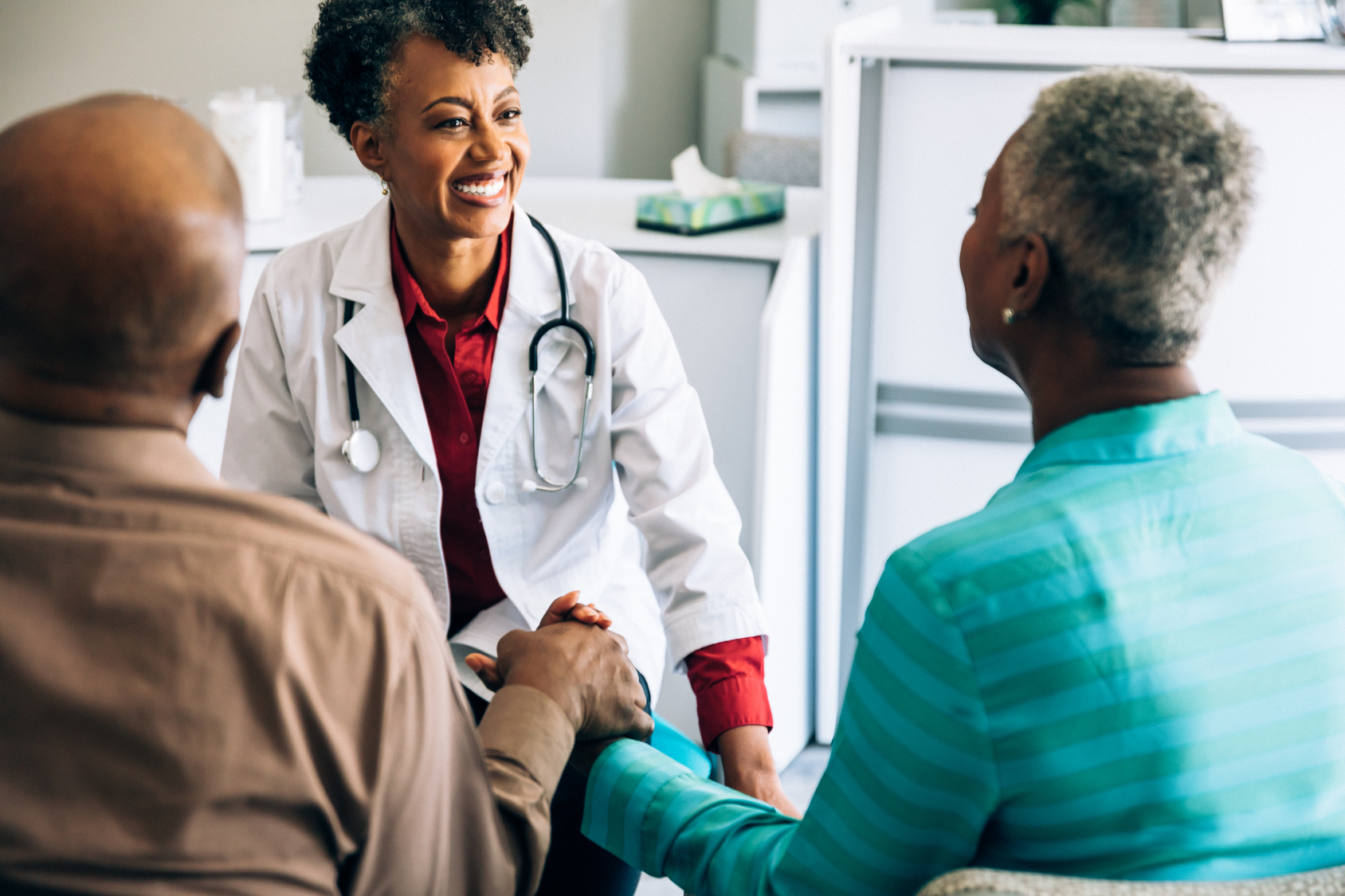 Doctor consulting mature couple